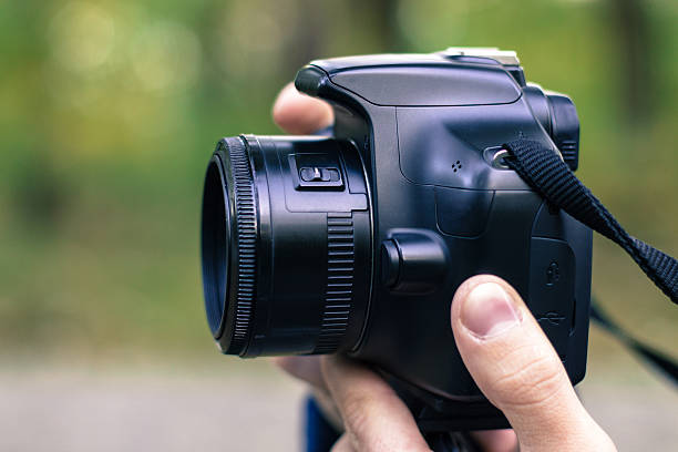 istock man taking picture with DSLR  camera 620696860