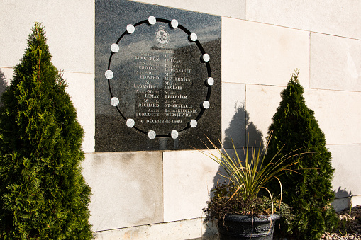 Montreal, Canada - November 1, 2016: Plaque commemorating the 14 females victims of the Ecole Polytechnique massacre, on the school's outside wall. On December 6th 1989, a man armed with a rifle and a hunting knife, shot 28 people, killing 14 women, before committing suicide. The killer targeted female students. The mass murder led to more stringent gun control laws in Canada.