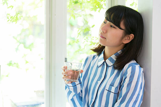 istock Japanese woman wearing pajama drinking water 620700030