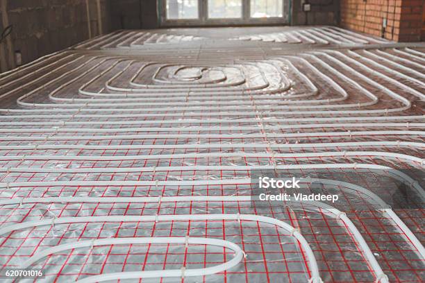 Heating Posed In A Under Construction Building Stock Photo - Download Image Now - Heat - Temperature, Glowing, Flooring