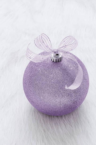 istock Purple glitter Christmas ornament close-up on white background 620702848