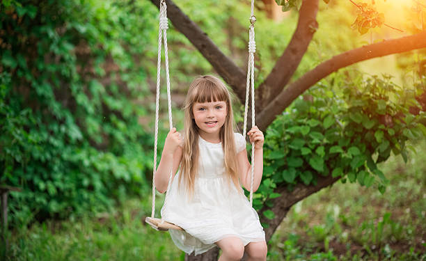 istock Little girl sitting on a swing 620702958