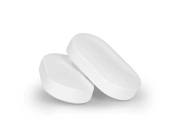 istock close-up of two pills isolated on white background 620703452