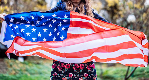 istock Young woman holding a flag 620703614