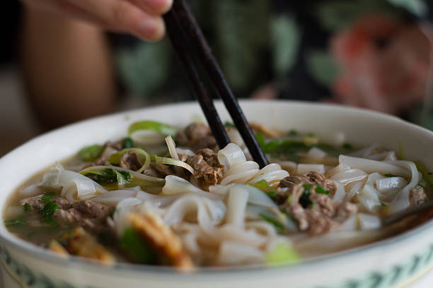 istock eating a bowl of Vietnamese beef noodle soup Pho Bo 620704976