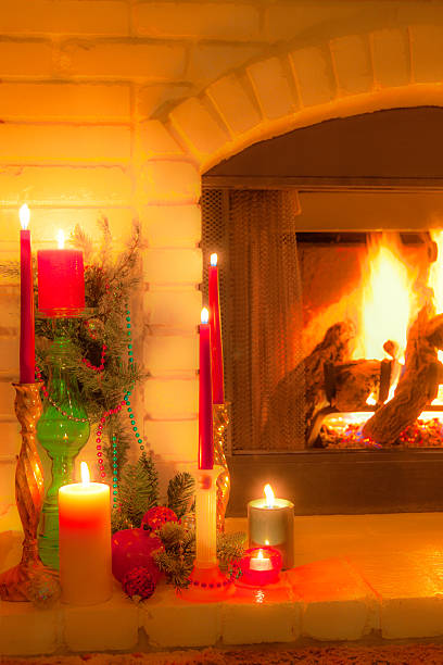 istock Old fashioned Christmas decorated fireplace with candles and logs (P) 620705122