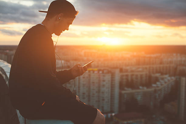 istock Brave man sitting on the top of the roof 620705636