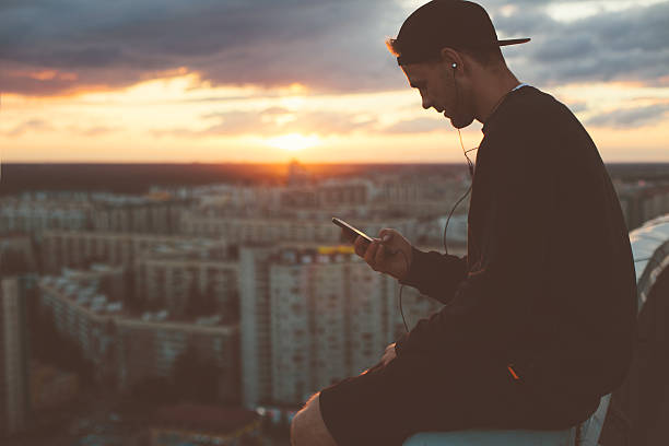 istock Risky man chilling on the edge of the roof 620705680