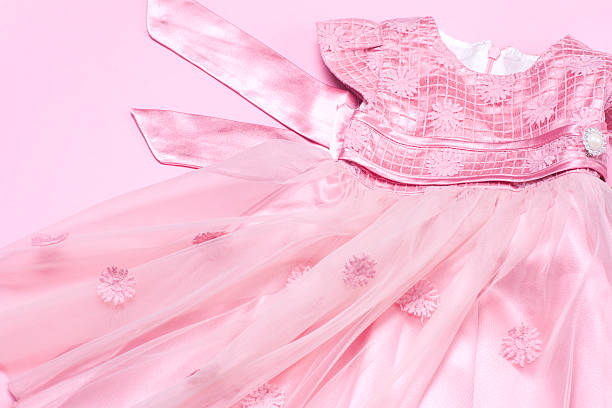 istock Clothes for baby girl on a pink background. Copy space 620710164