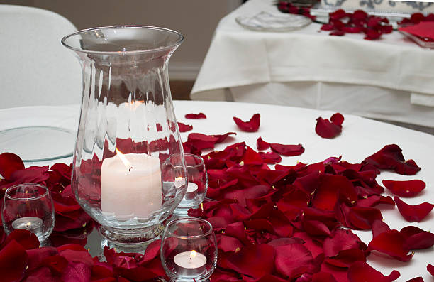 istock Candle And Rose Petals Center Piece On A Table 620710340