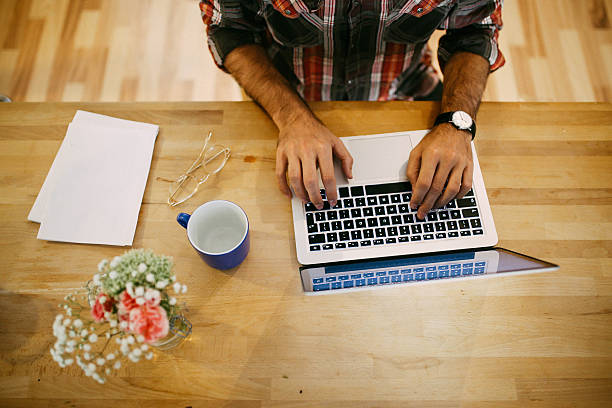 istock Young man having a coffee and working at home 620710816