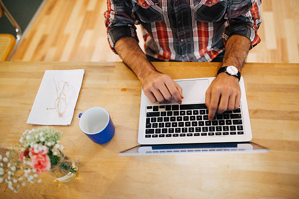 istock Young man having a coffee and working at home 620710872