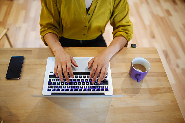 istock Young woman having a coffee and working at home 620710940