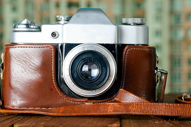 istock Old retro camera on vintage wooden boards abstract background. 620711188