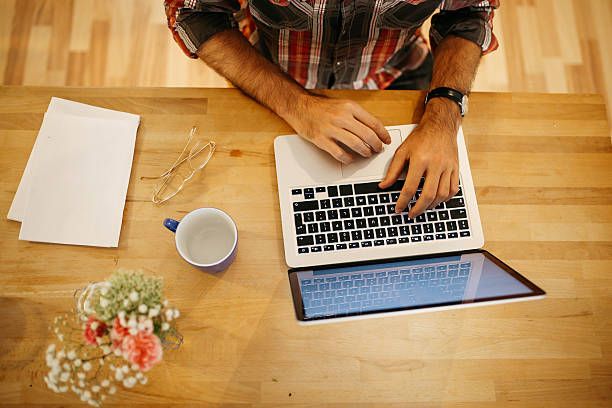 istock Young man having a coffee and working at home 620711208