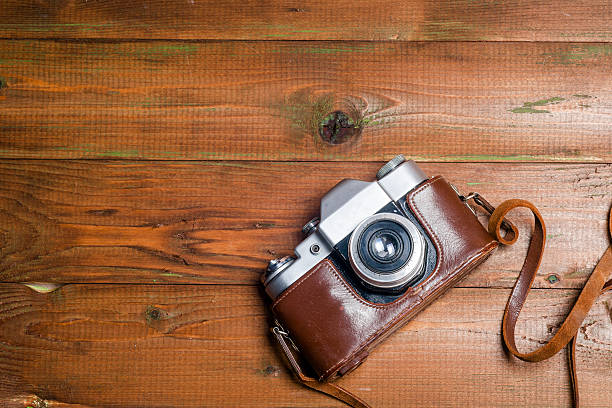 istock Old retro camera on vintage wooden boards abstract background. 620711250