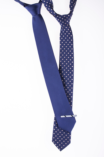 two blue tie with tied knots on the white background