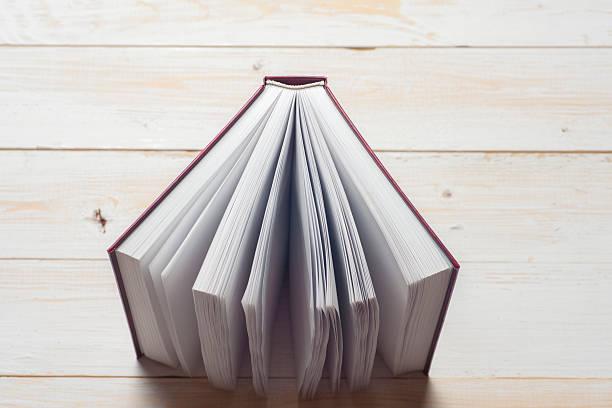 istock Top view of bright colorful hardback books in a circle. 620712534