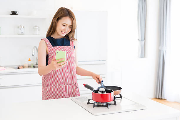 istock Japanese woman cooking in kitchen 620712648
