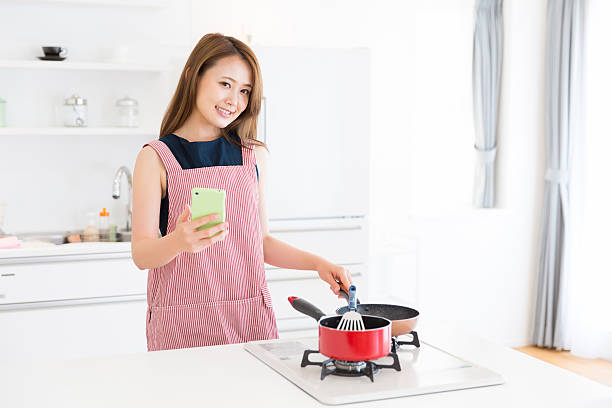istock Japanese woman cooking in kitchen 620712666
