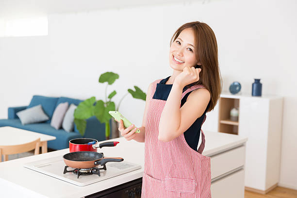 istock Japanese woman cooking in kitchen 620713084