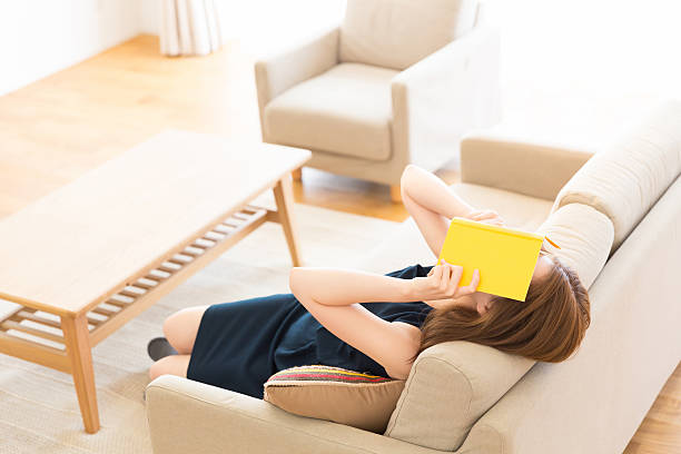istock Japanese woman reading a book 620713870