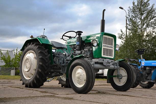 Classic Ursus C-330 tractor Warsaw, Poland - 14th June, 2014: Classic Ursus C-330 tractor stopped on the street during the tractors parade. The Ursus Factory was founded in Poland in 1893. In the years 1970-1990 Ursus was one of the biggest tractors producers in the world. On the photo we see the C-330 model with years1967-1987. ursus tractor stock pictures, royalty-free photos & images