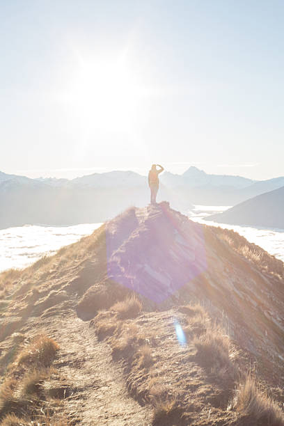 istock Hiker on top of mountain looks at view 620717910