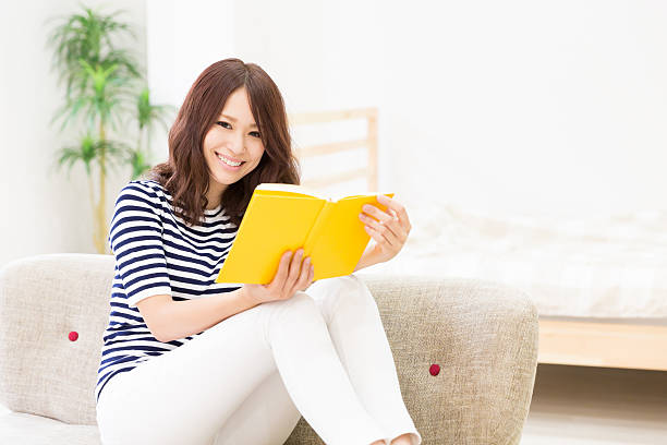 istock Japanese woman reading a book 620719284