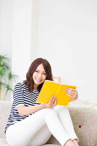 istock Japanese woman reading a book 620719304