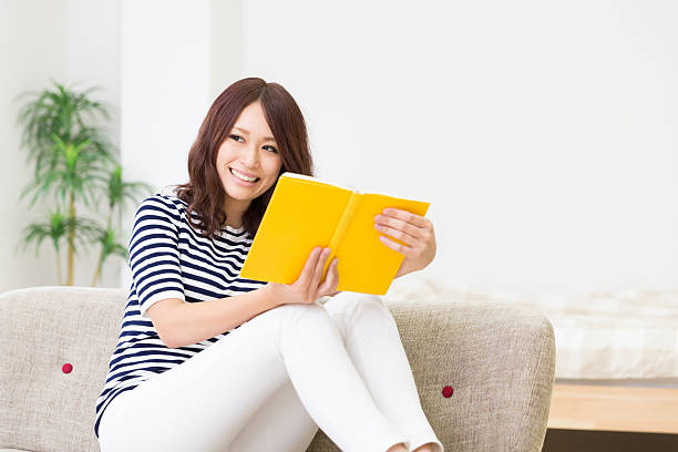 istock Japanese woman reading a book 620719326