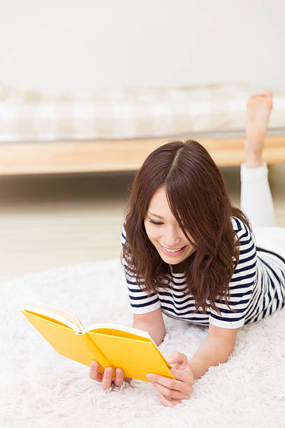 istock Japanese woman reading a book 620720778