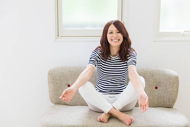 istock Japanese woman sitiing on a sofa 620721058
