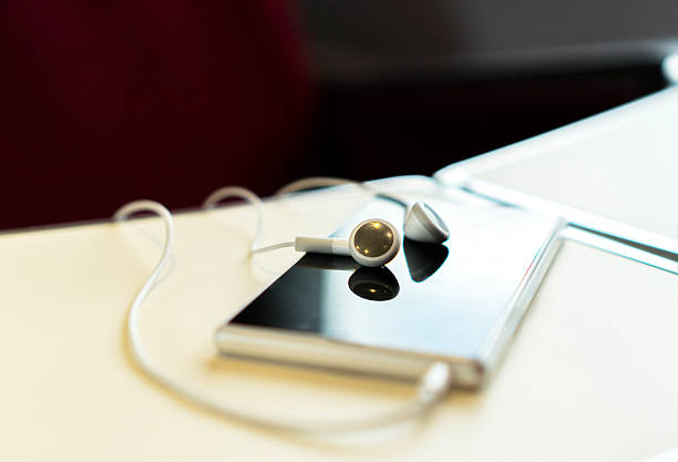 istock mobile phone and earphone on train desk 620721528