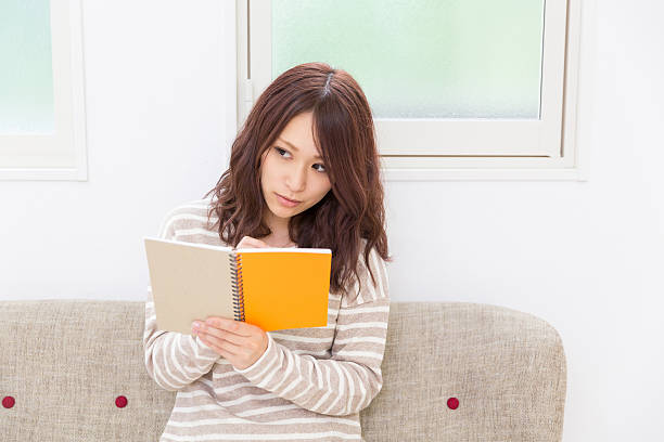 istock Japanese woman writing on a notebook 620723194