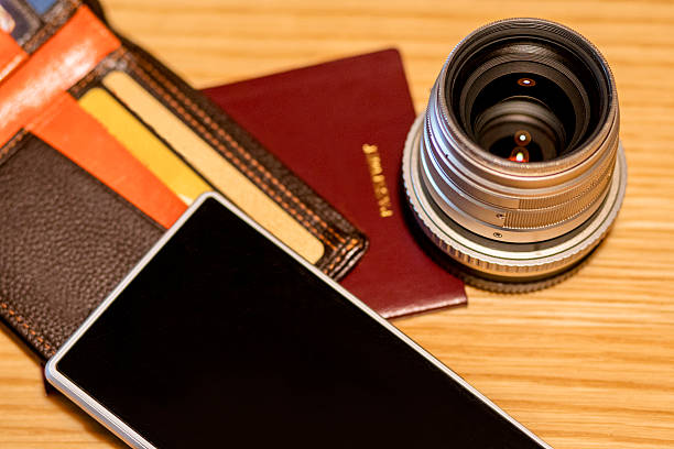 istock wallet,passport,mobile phone and camera lens 620723632