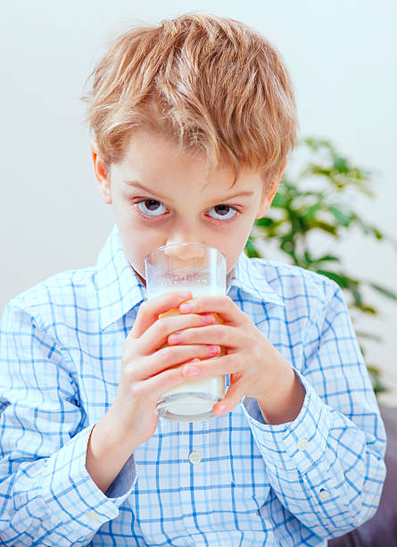 istock Boy eating yogurt, close up 620724412