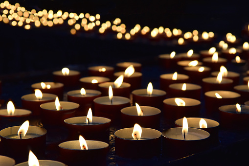 burning memorial candles on the dark background