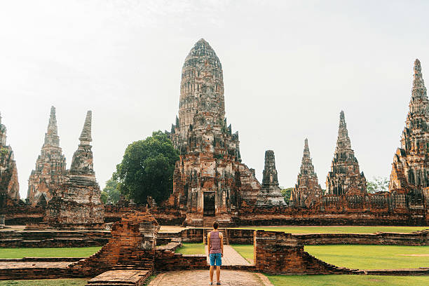 istock Man near Ancient Buddhist Temple 620727206