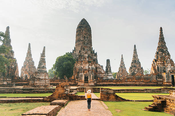 Ancient Buddhist Temple Woman walking near the ancient Buddhist Temple in Ayutthaya, Thailand ayuthaya photos stock pictures, royalty-free photos & images