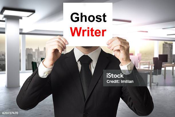 Businessman Hiding Face Behind Sign Ghost Writer Stock Photo - Download Image Now - Ghost, Writing - Activity, Author