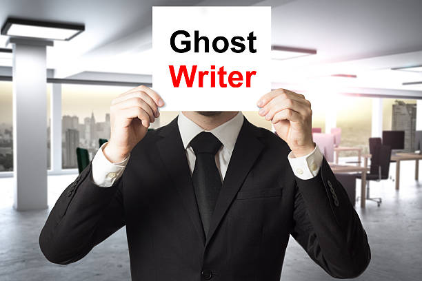 biznesmen ukrywa twarz za znakiem ghost writer - book holding necktie businessman zdjęcia i obrazy z banku zdjęć