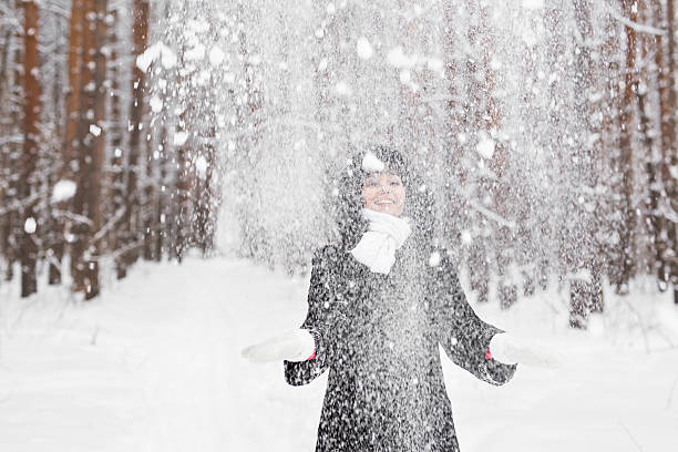 istock Happy young woman having fun in the snow 620727482