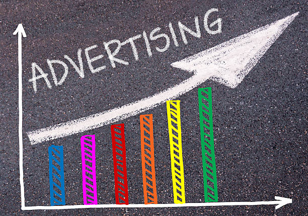istock ADVERTISING written over colorful graph and rising arrow 620728110
