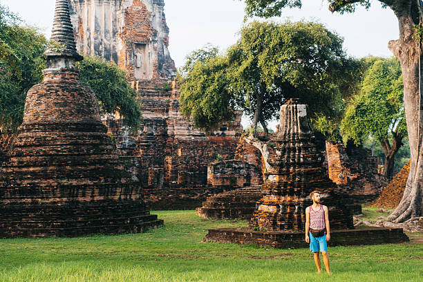 istock Man standing near ancient Buddhist Temples 620728336