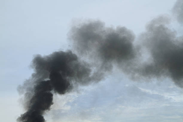 istock Black smoke from fire burning on the sky 620728476