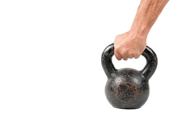 istock Hand holding old and rusty Kettle Bell isolated 620729300