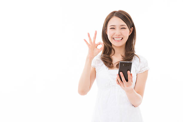 istock Japanese woman holding a smart phone 620730032