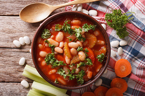 istock Rustic bean soup with ingredients close up. horizontal top view 620732198