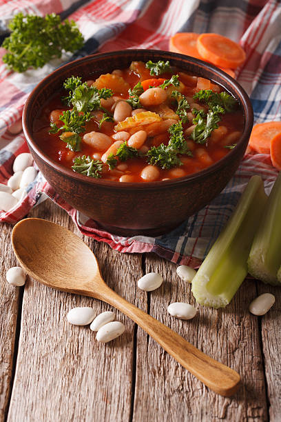 istock soup with beans, carrots and celery. vertical 620734924